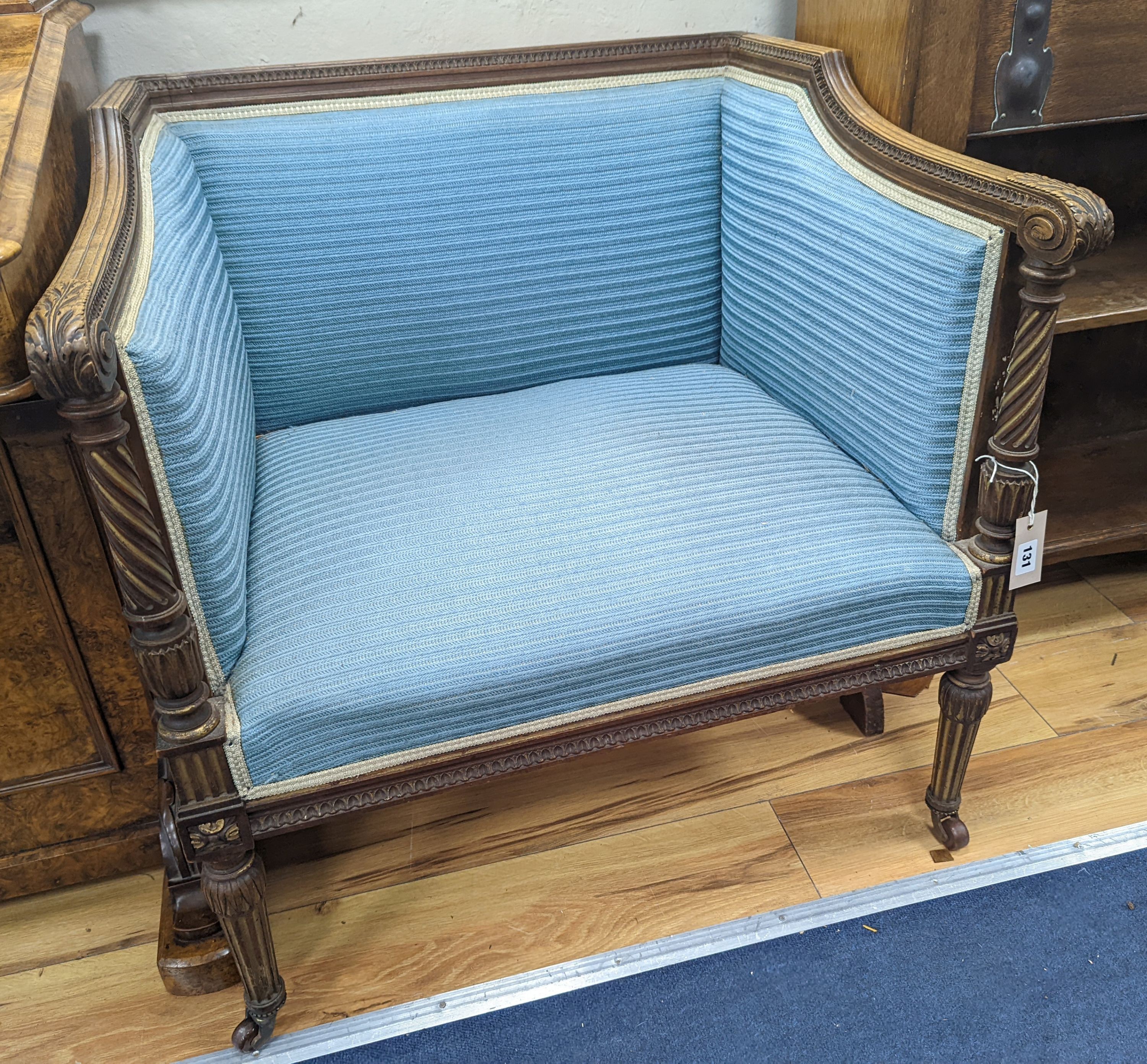 A pair of French walnut and parcel gilt Bergere chairs, width 71cm, depth 59cm, height 72cm